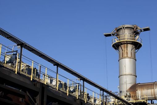 Tall metal tower with a clock on to