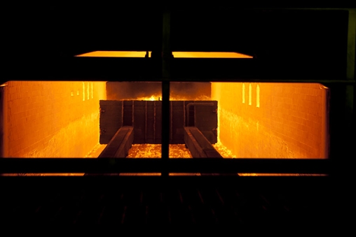 Roaring fire inside, casting a warm glow in a dark room