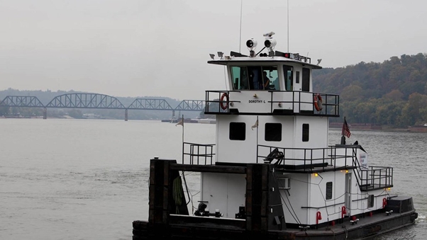 Tug boat moving along a river