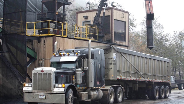 Large truck parked in front of a brick building