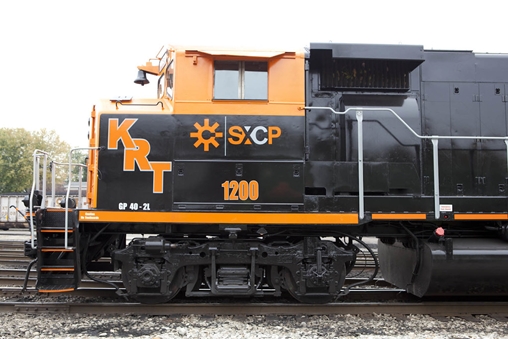 Black and orange train engine on the tracks