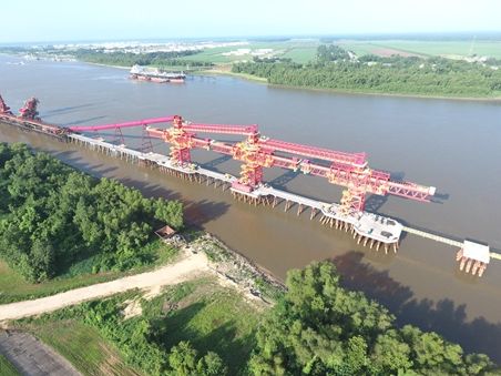 Large bridge spanning a river, connecting two sides