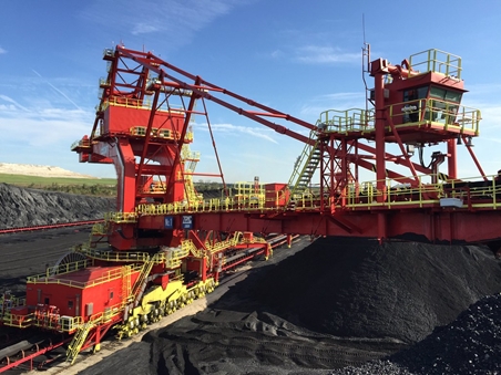 Coal conveyor belt with a crane in front, ready for loading coal