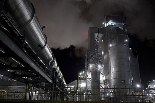 Sprawling industrial plant with billowing smoke